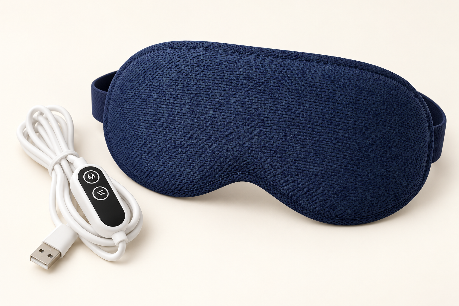 Sleepiti heated eye mask in dark blue with its two-button USB controller.